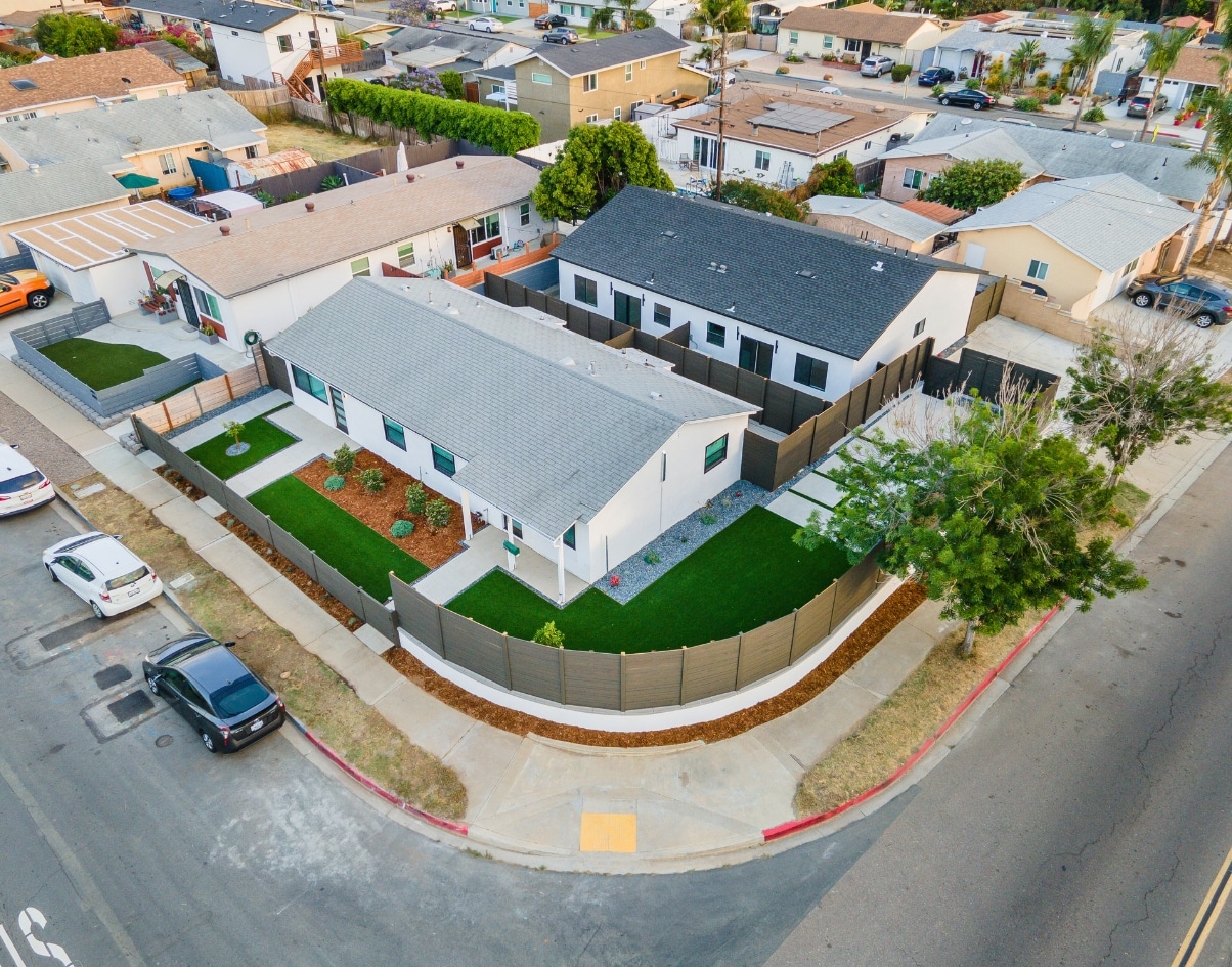 Aerial view of multiple ADUs with finished landscaping and fencing, illustrating the value of using an ADU cost calculator to plan projects, optimize costs, and enhance property potential.