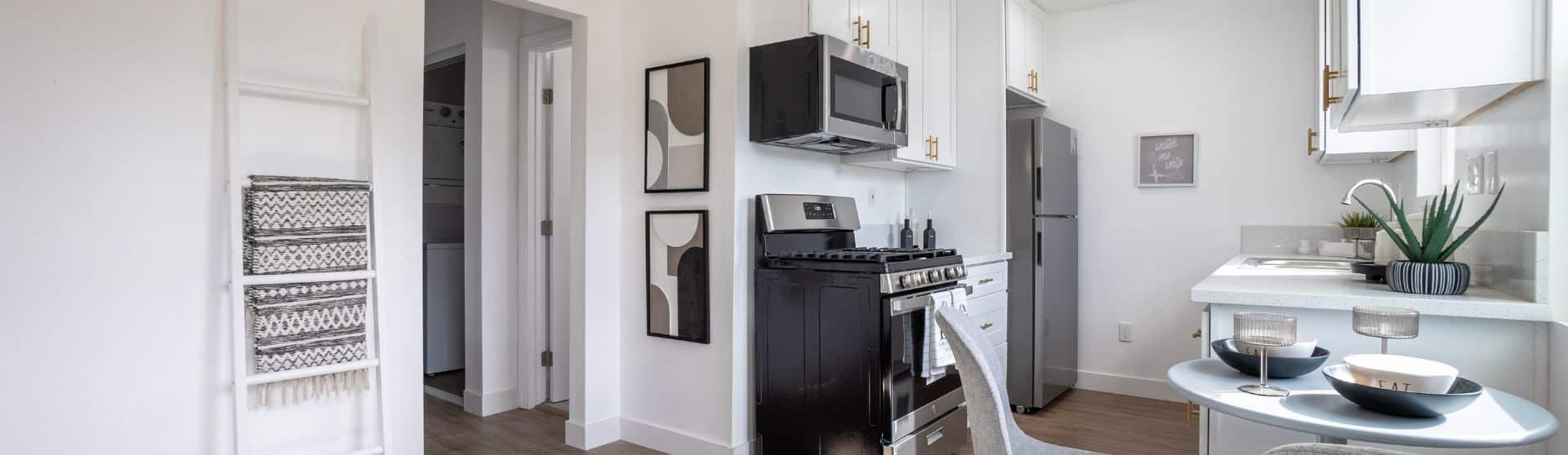 Bright and modern kitchen and dining area showcasing a stylish garage conversion ADU, featuring ample natural light, sleek white cabinetry, and a seamless indoor-outdoor flow.