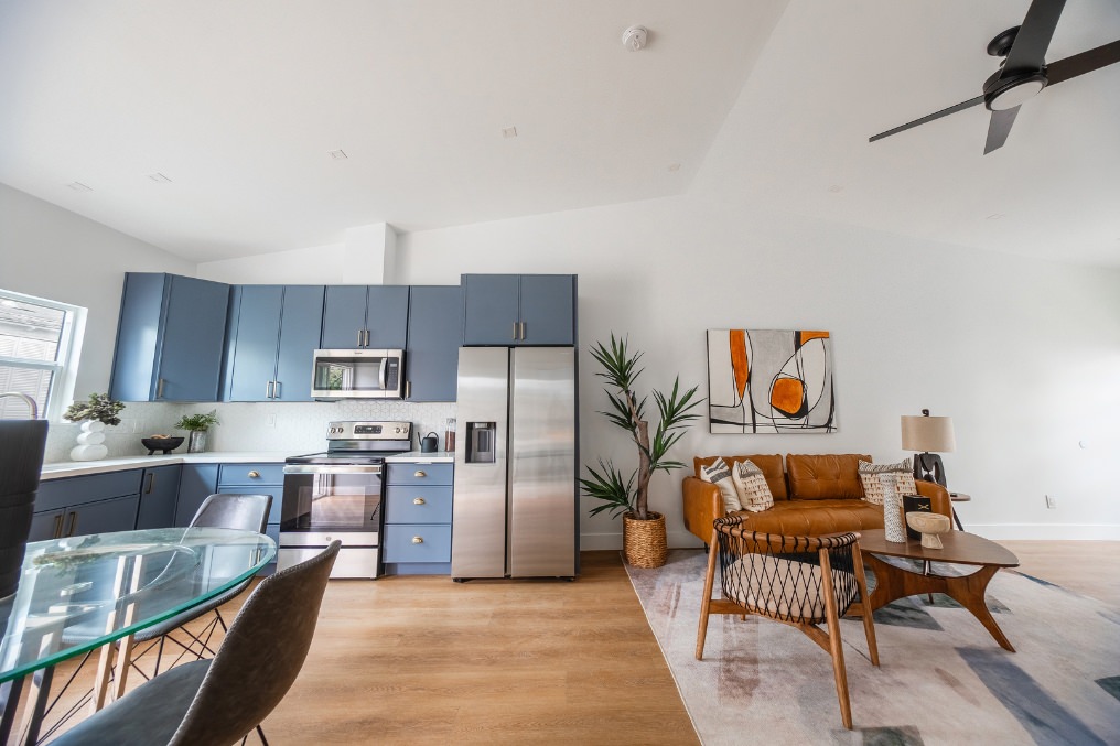 Bright, modern kitchen overlooking stylish living room with leather sofa in Pacific Beach detached ADU.