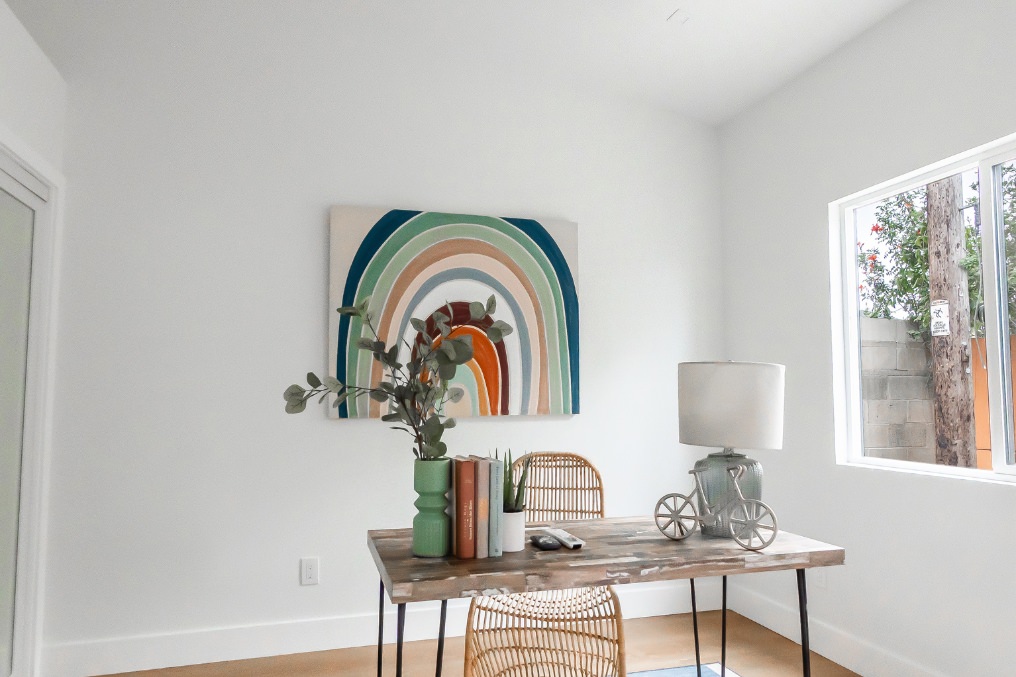 Cozy home office with minimalist decor, natural light, and artistic accents in Pacific Beach detached ADU.
