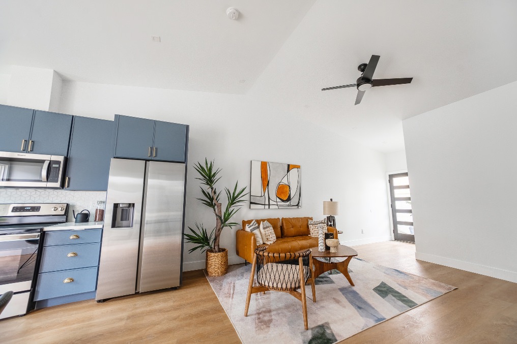 Modern open-concept kitchen and living space with blue cabinetry and minimalist decor in Pacific Beach detached ADU.