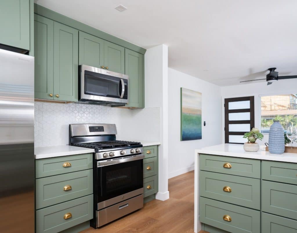 Modern ADU kitchen with a sleek gold faucet, stainless steel sink, and premium backsplash tiles showcasing quality materials.