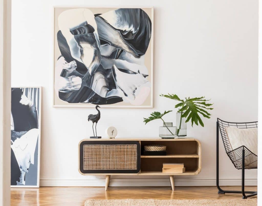 Stylish console table with abstract art and modern decor accents in a living room.