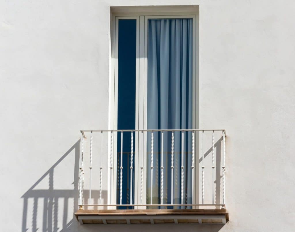 Wrought iron balcony detail on a Spanish-style ADU, adding elegance and authenticity.