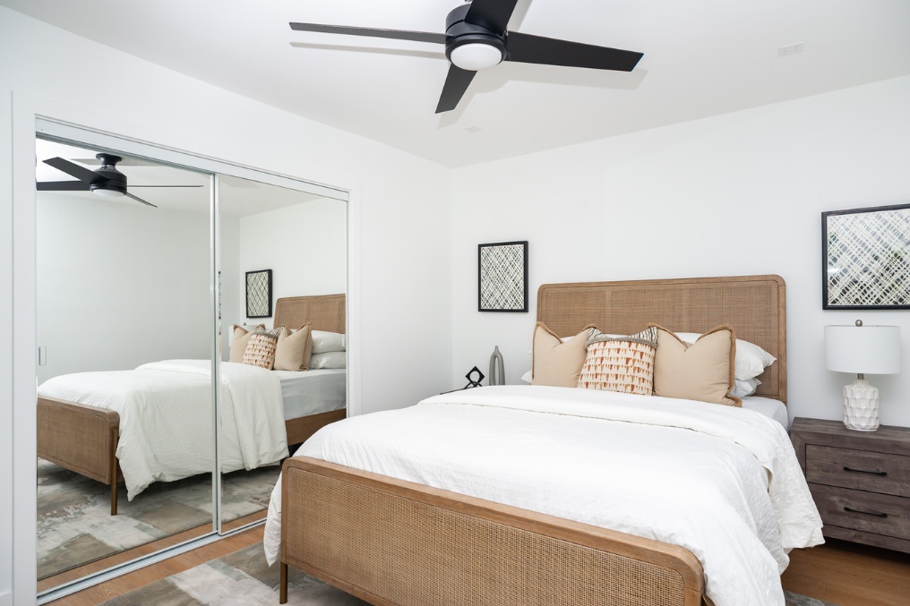 Inviting primary bedroom with Scandinavian-style furniture and mirrored closet in Clairemont ADU