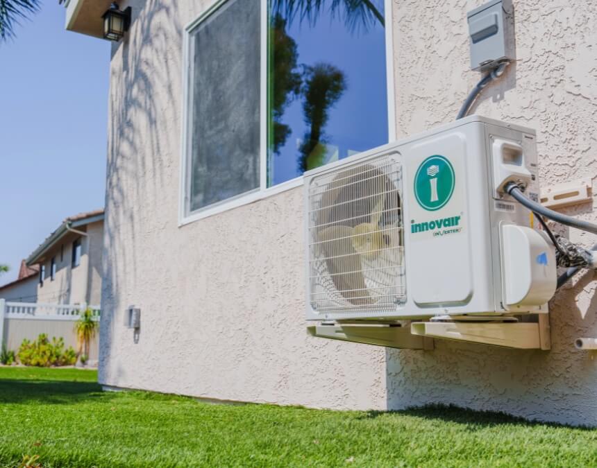 Electrical panel and outdoor AC unit illustrating load calculation for ADU power demand.