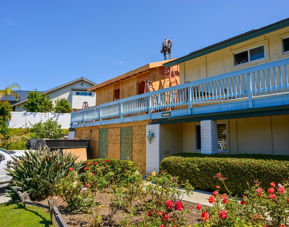 Construction work on a two-story home in San Diego, adding a junior ADU to expand living space and increase property value through an attached accessory unit.