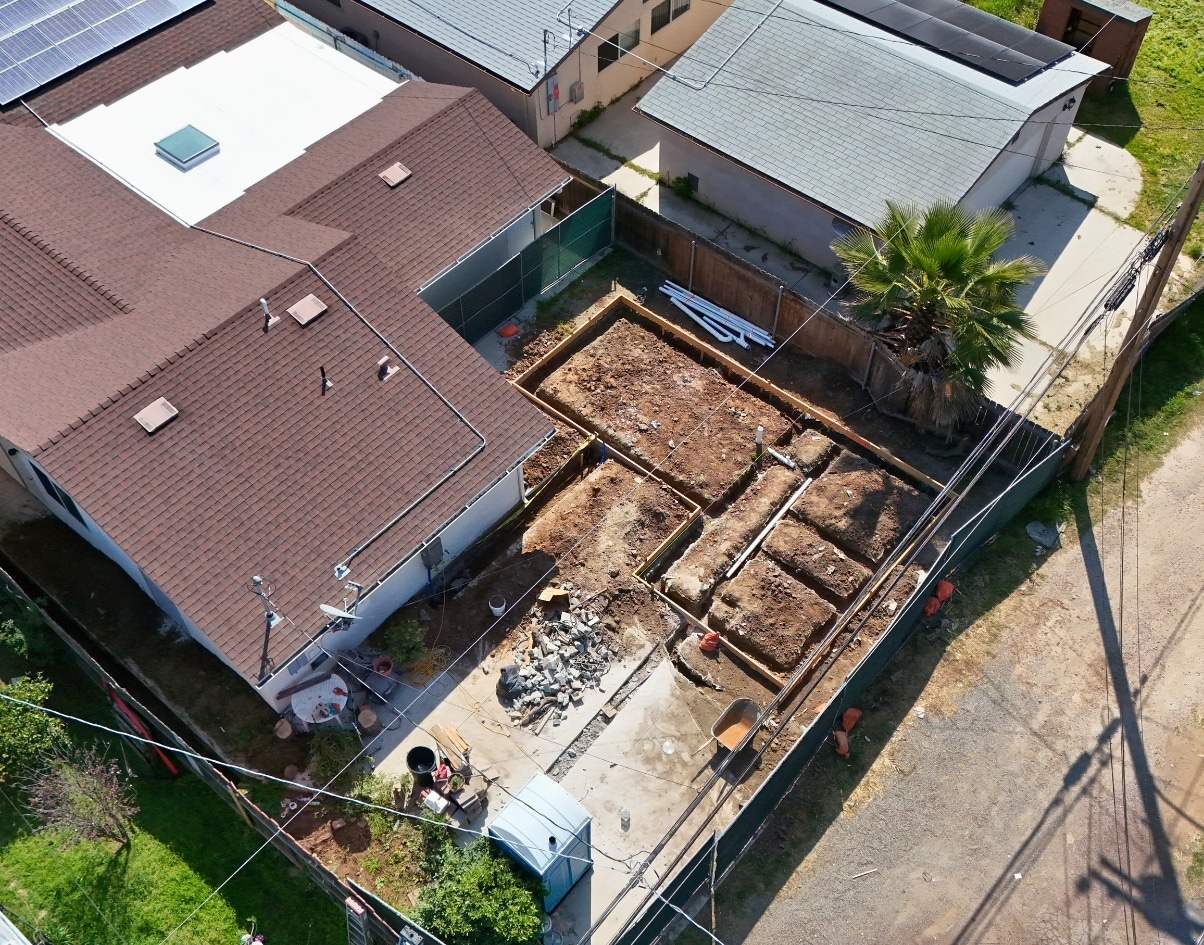 Aerial view of backyard foundation work in San Diego for a junior ADU project, highlighting the early construction phase of an accessory dwelling unit.