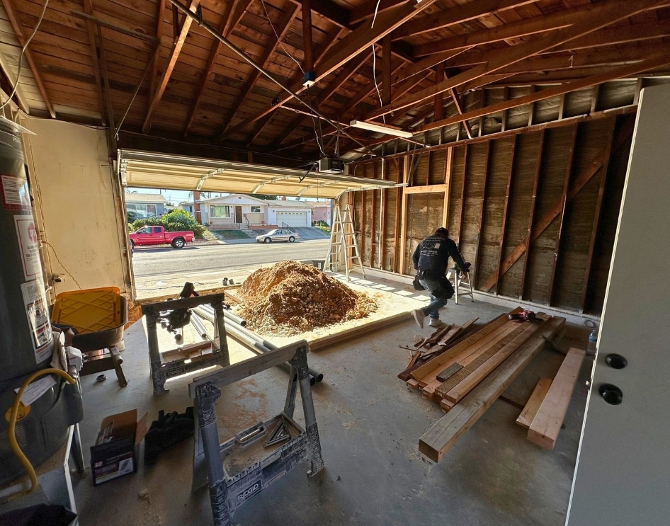 An active ADU garage conversion in Greater San Diego, showing exposed framing, materials, and site preparation work. Focuses on the setup for utility connections, including the integration of electrical, plumbing, and sewage systems, which are essential for transforming garages into fully functional, standalone ADUs.