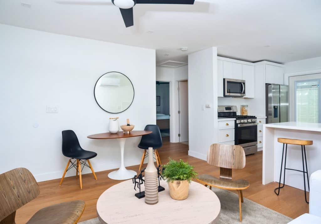 Neutral area rug adding warmth and defining the living area in an ADU