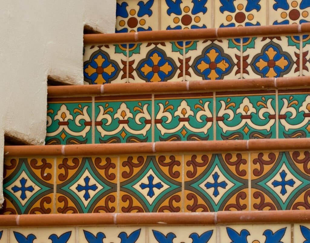 Colorful decorative tile stairs leading to a Spanish-style ADU.