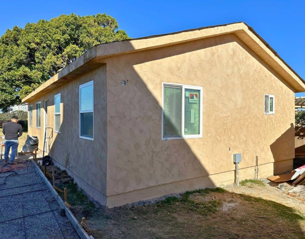 Completed detached Accessory Dwelling Unit with modern stucco exterior.