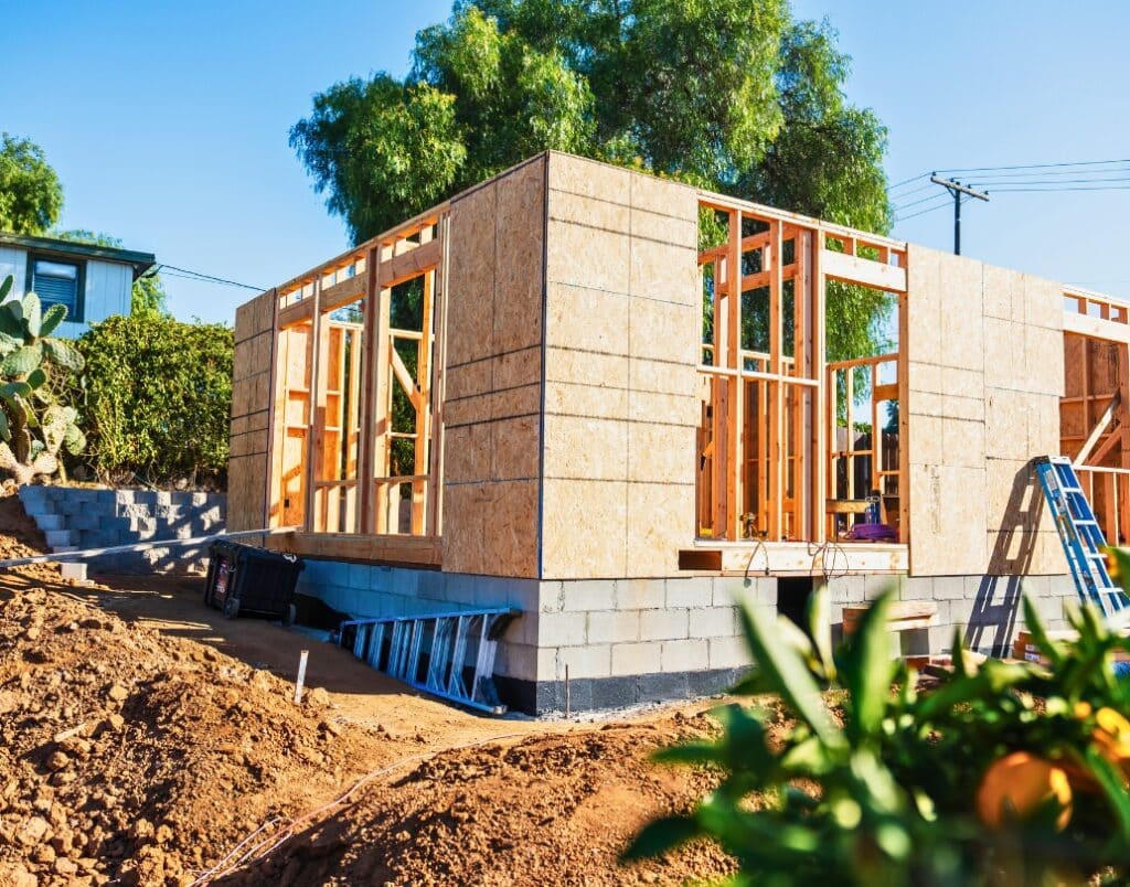 A newly framed ADU under construction, showcasing a partially built wooden structure.