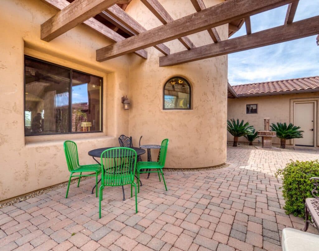 Spanish-style ADU with an outdoor patio featuring a pergola and stucco walls.