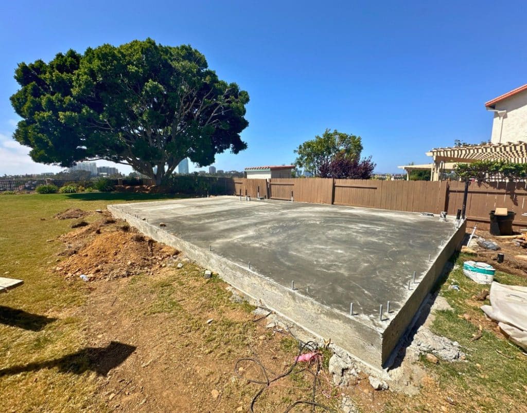 Construction of a raised foundation for an ADU with visible footings and wooden supports.