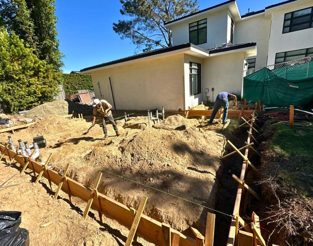 A newly poured slab-on-grade foundation for an ADU construction project.