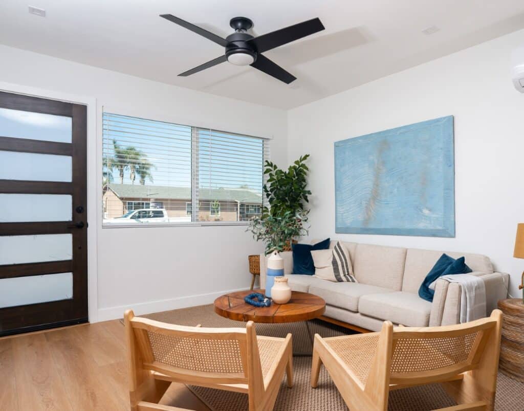 A cozy ADU living room with neutral decor and a ceiling fan.