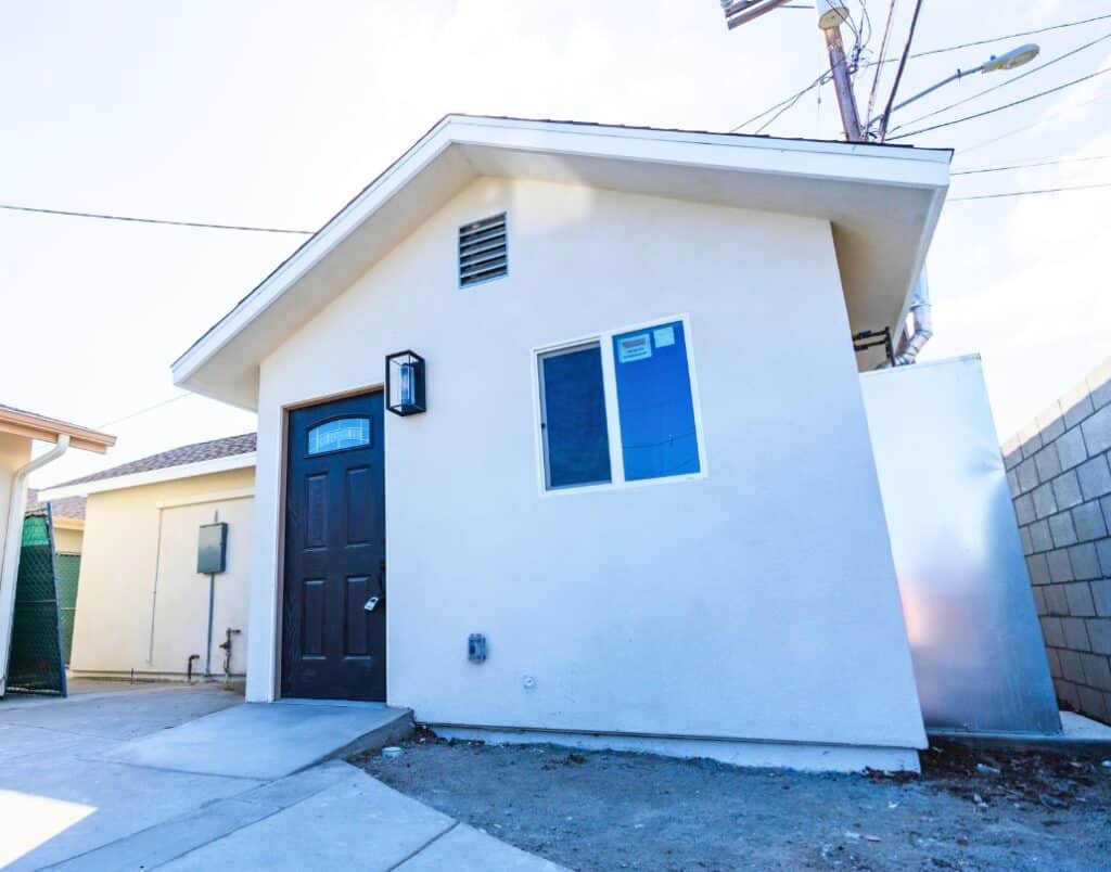 Exterior of a compliant ADU in California with a separate entrance and private utilities.