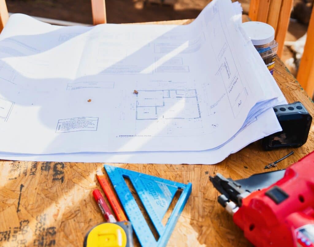 Construction plans and tools laid out for designing an Accessory Dwelling Unit (ADU).