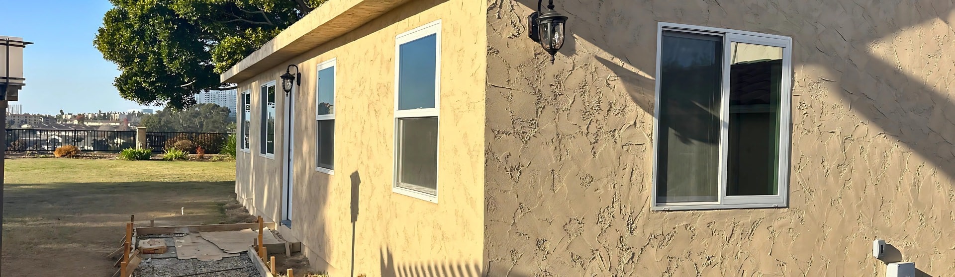 A finished detached ADU in California with textured stucco walls and modern fixtures, exemplifying compliance with state laws for independent living units.