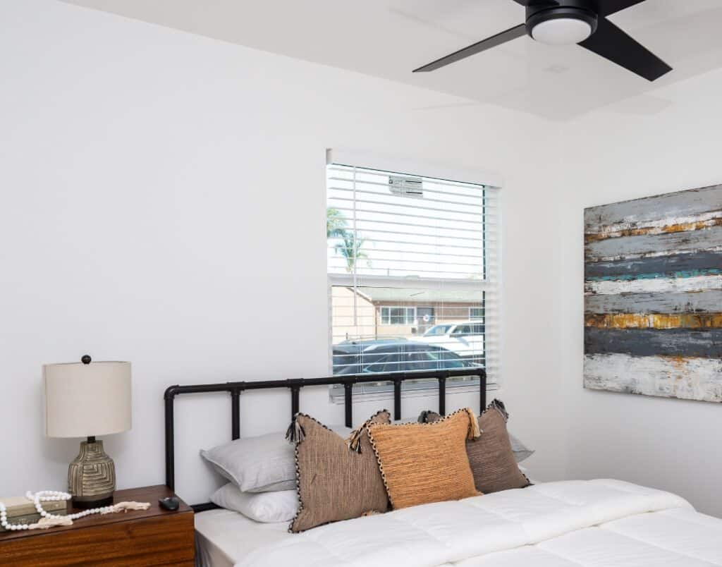 A modern bedroom featuring a large operable window, ensuring compliance with California’s egress requirements for fire safety and natural ventilation.