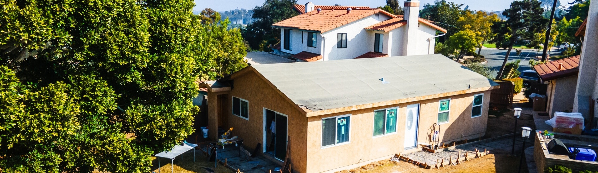Nearly completed ADU structure behind a primary home in a residential San Diego neighborhood.