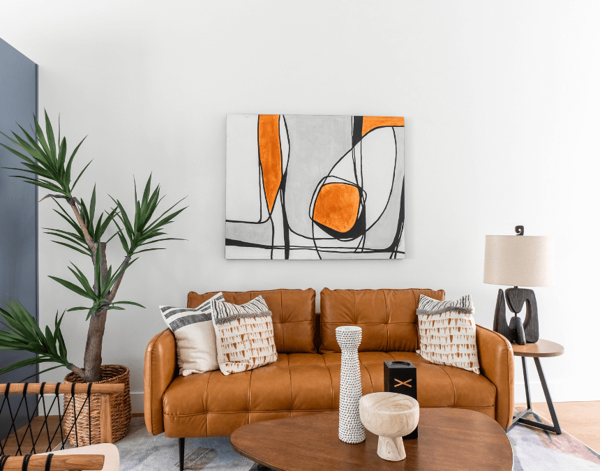 Stylish ADU living room with natural materials, houseplants, and soft ambient lighting that promote indoor air quality and biophilic design.