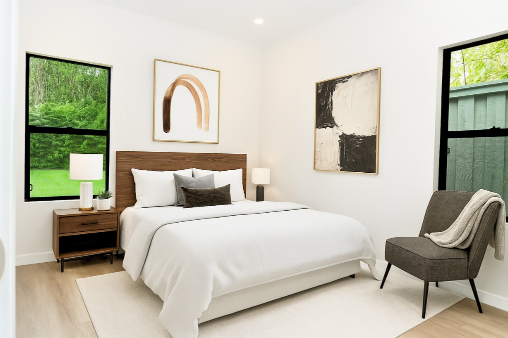 Bright ADU bedroom featuring large windows, modern decor, and contemporary furniture arrangement.