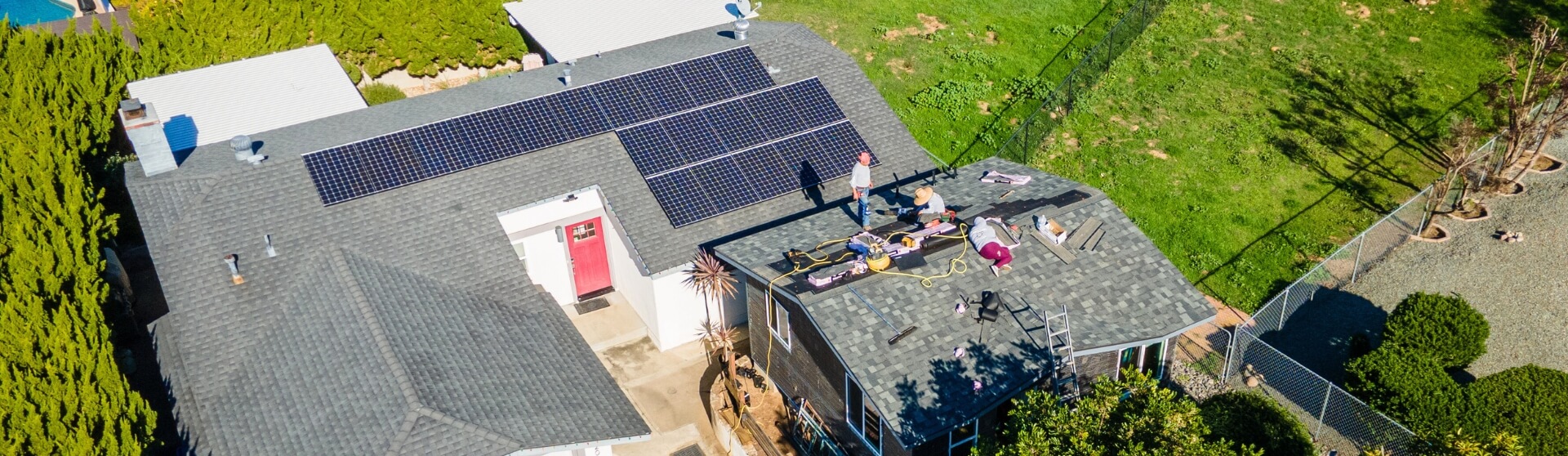 Aerial view of residential homes in San Diego with visible solar panels on rooftops, illustrating energy-efficient ADU design integration.