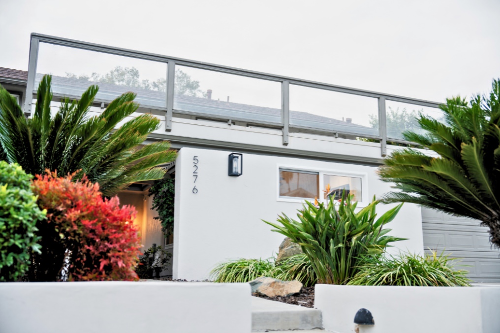 Contemporary white exterior with lush landscaping of garage conversion studio ADU in San Diego