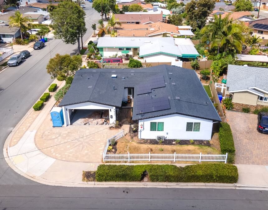 San Diego suburban home with neatly installed solar panels and ADU site preparation underway.