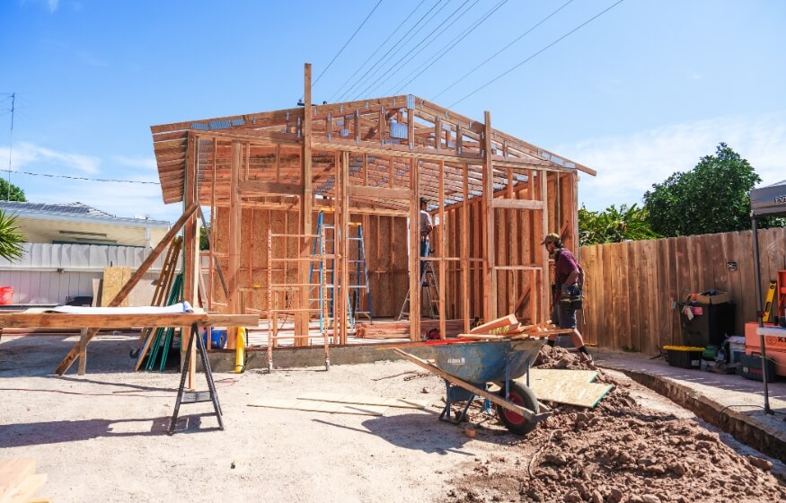 Construction of a 1200 square foot ADU in progress, showing wood framing and builders on-site