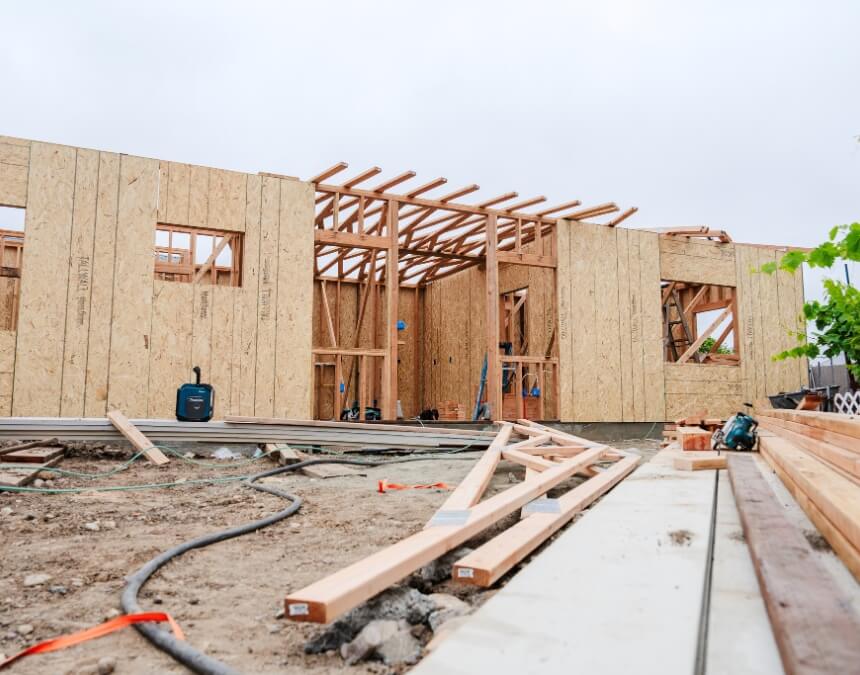 Framing of an ADU construction site showing trenches and electrical lines for utility connection considerations.