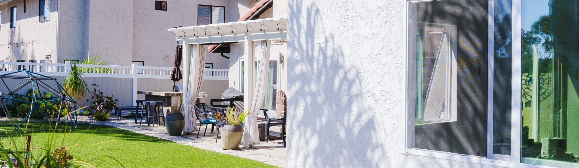 What to Consider When Downsizing to ADU Living backyard with patio space beside a white ADU