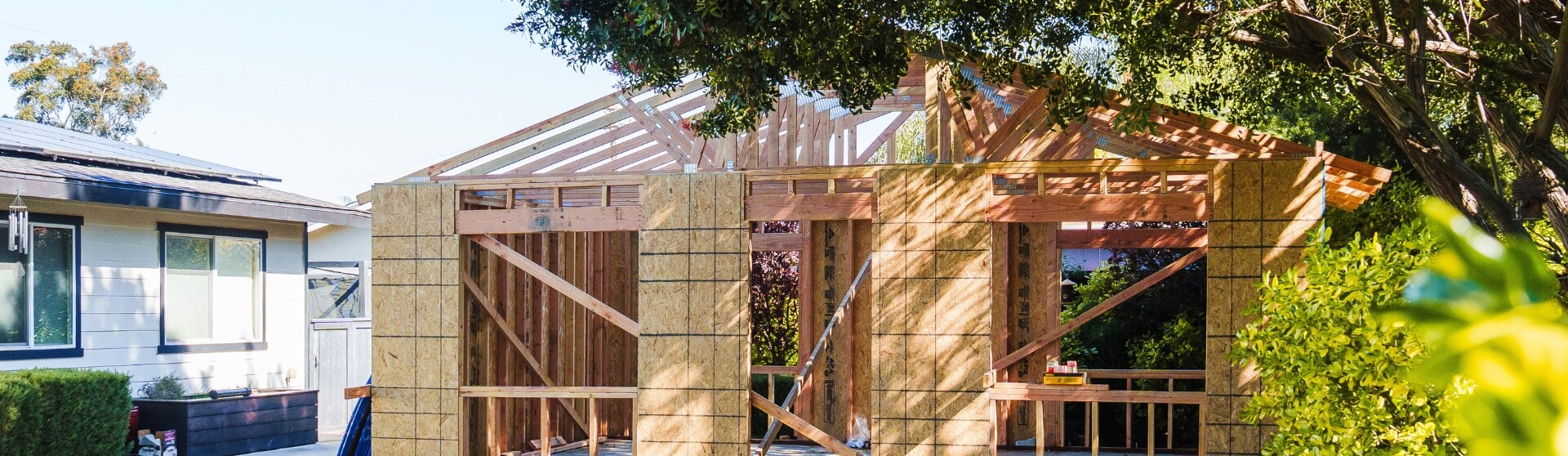 Aerial view of a San Diego neighborhood with a detached backyard unit — What Is ADU Construction illustration for Better Place Design & Build blog.