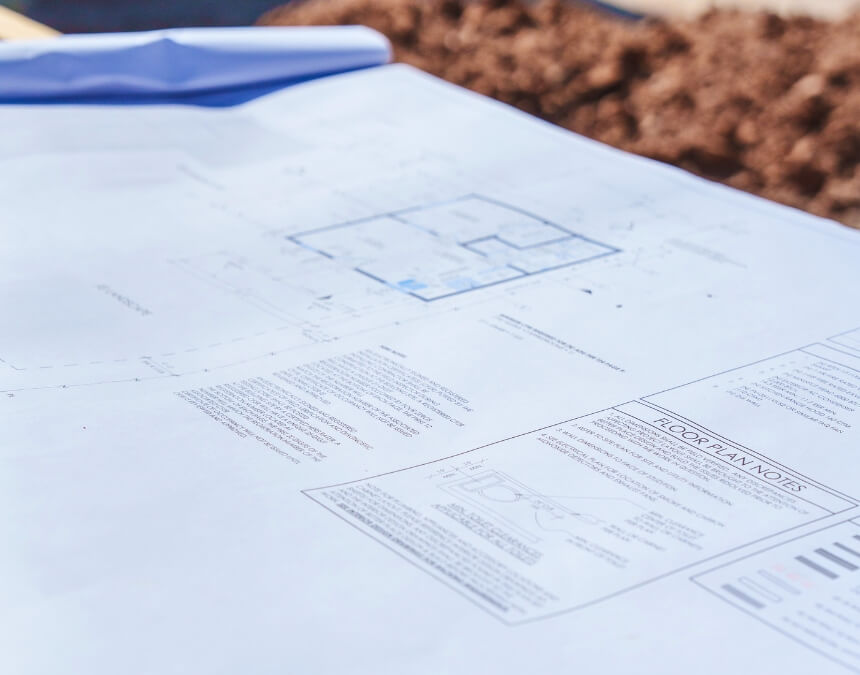 “Builder Communication Standards” image of architectural plans laid out onsite for an ADU project.