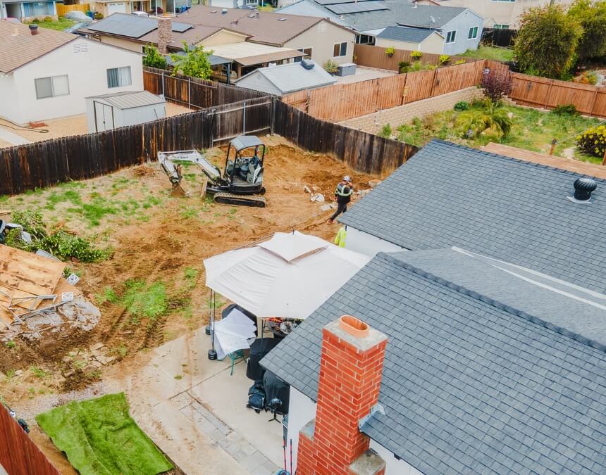 Considering Local Regulations & Guidelines” active backyard construction site with equipment, showing a typical San Diego ADU work zone.