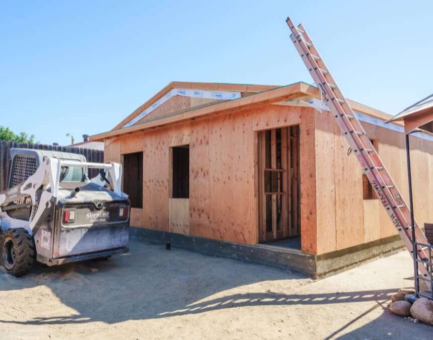 “Determining the Need for a Survey” ADU in early framing stage on a residential site, indicating a point where verification may be required.