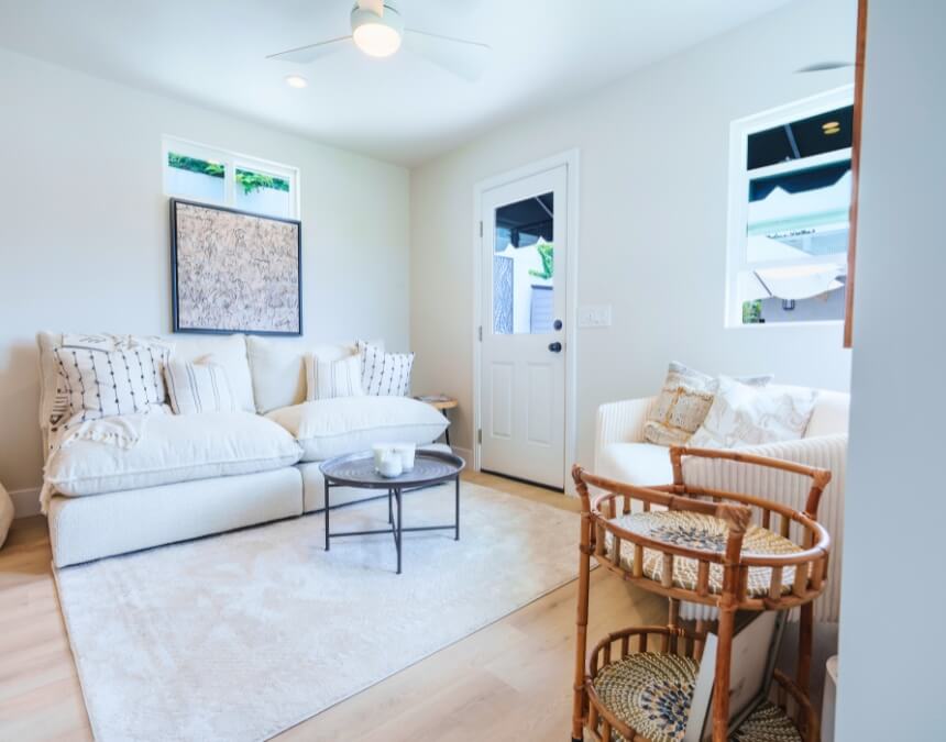 “Pricing & Contract Transparency” image of a completed ADU living area with bright finishes and staged seating.
