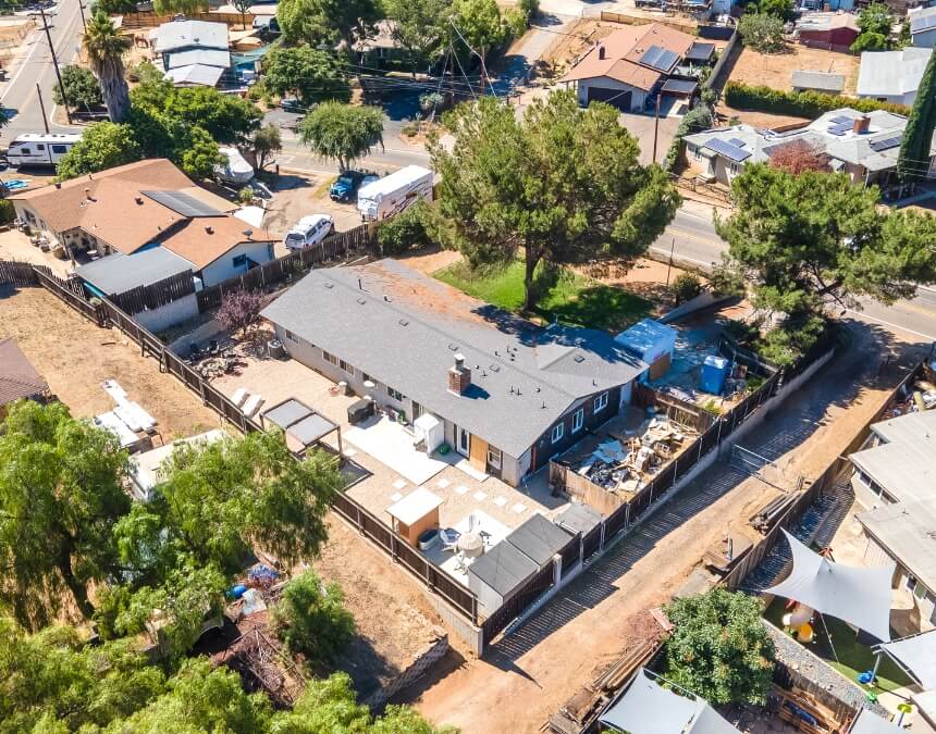 Pros and Cons of Using a HELOC to Build an ADU – aerial view of a single-family San Diego home with backyard space and active construction area for an ADU.
