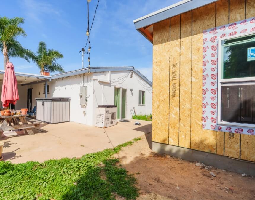 How Much Does It Cost to Build an ADU in California detached backyard ADU construction progress beside existing home